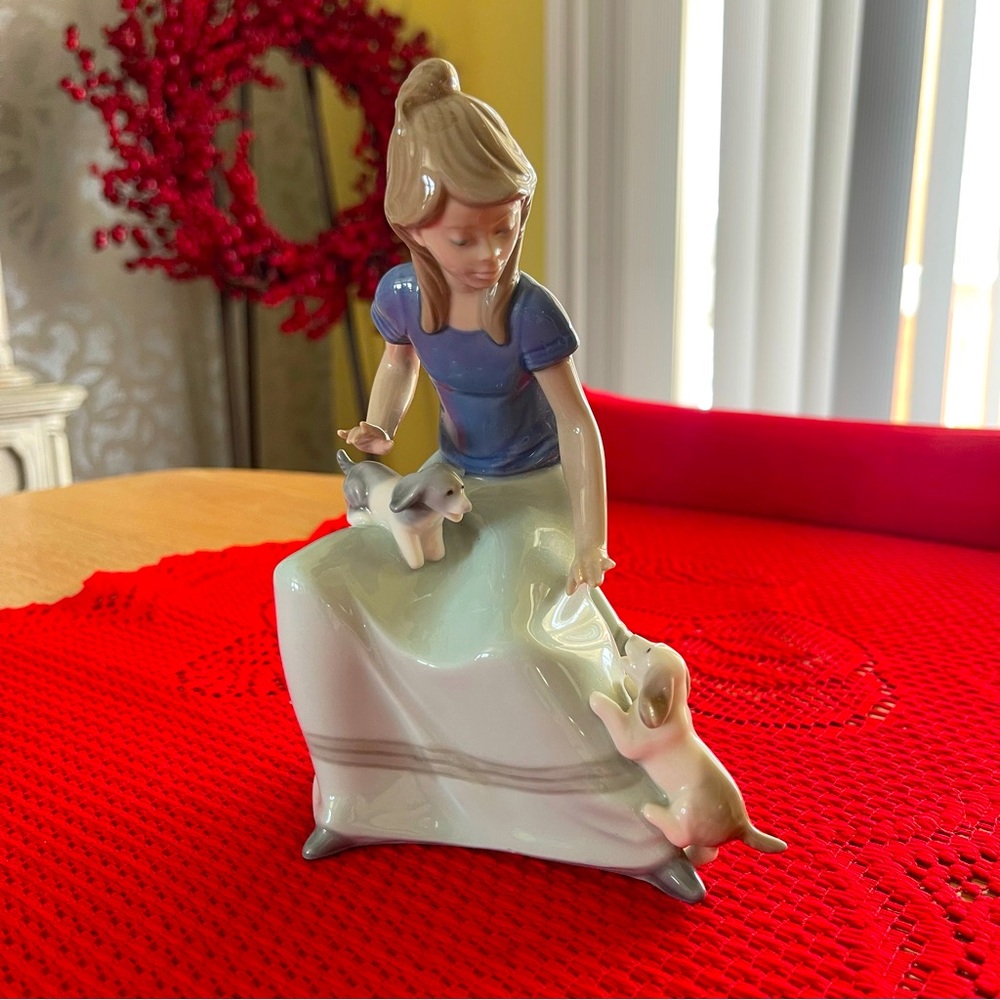 Lladro Perfect pristine condition. Lady sitting with two puppy dogs. Rare. Offer